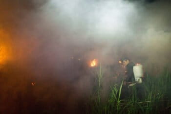 Members of the local community help extinguish the fire of burning peatland in Kapuas district, Central Kalimantan province on Borneo island, Indonesia.