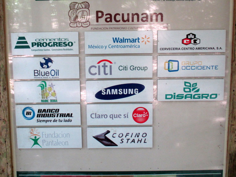 Pacunam's corporate members are listed on a sign at the Mirador archaeological site in Guatemala's Maya Biosphere Reserve. Photo by Sandra Cuffe.