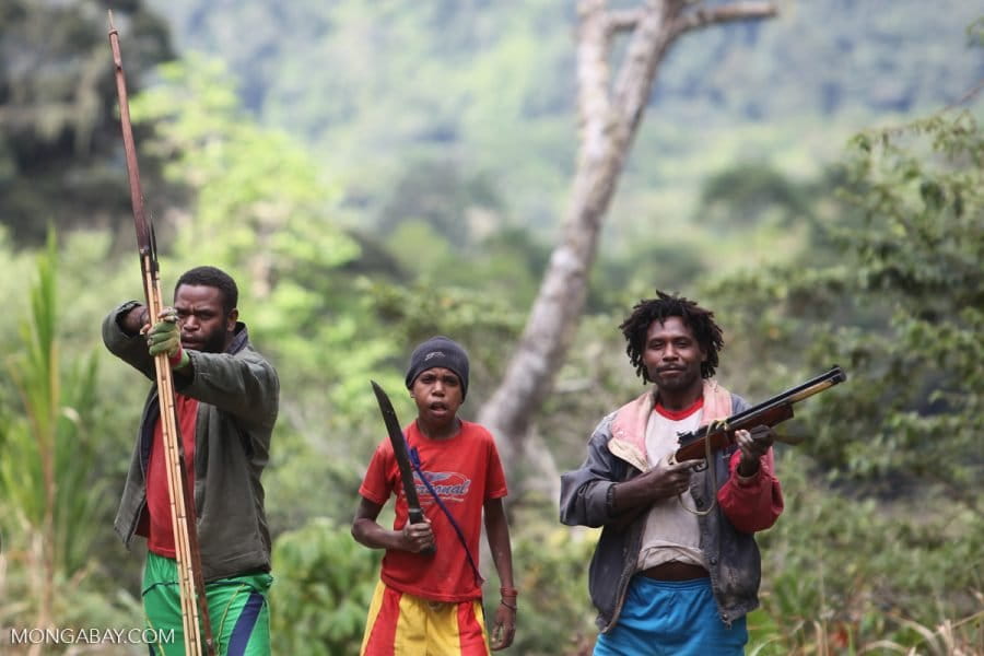 Mouley men and a boy brandish their weapons in West Papua. Photo by Rhett Butler/Mongabay