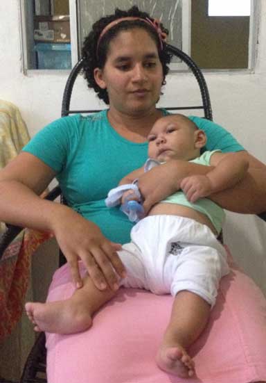 Mother and child: Jaqueline Vieira de Souza holds her son, Daniel, a victim of Zika and microcephaly. She spoke to reporters in her home on the outskirts of Recife. Brazil has seen 1,600 confirmed cases of microcephaly linked to Zika so far. Photo by Zoe Sullivan 