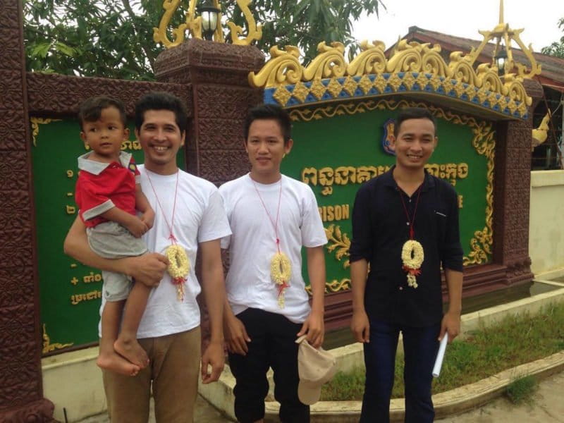 Sim Somnang reunited with his son (left), Try Sovikea (center), and San Mala (right) stand outside Koh Kong prison, having just been released. Photo by Mot Kimry/Mother Nature Cambodia.