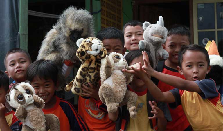 Children in the Little Fireface Project's Nature Club ('Klub Alam') play with wildlife puppets. Conservation education is key to conserving lorises. Photo by Daniel Geerah