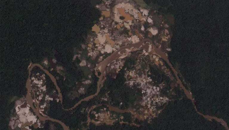 An illegal mining camp near Las Claritas, part of the Orinoco Mining Arc. Pools of mud, likely contaminated with mercury, have replaced the forest. Criminal gangs control the area and sell the rights to mine. Source: Google Maps