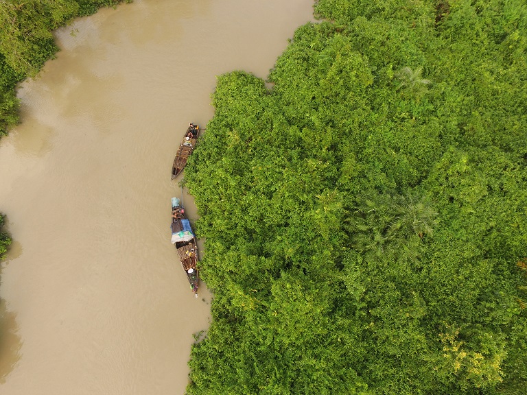 A drone image shows people in boats loaded with wood inside the MKWS mangrove sanctuary in October 2016. Photo courtesy of Fauna & Flora International