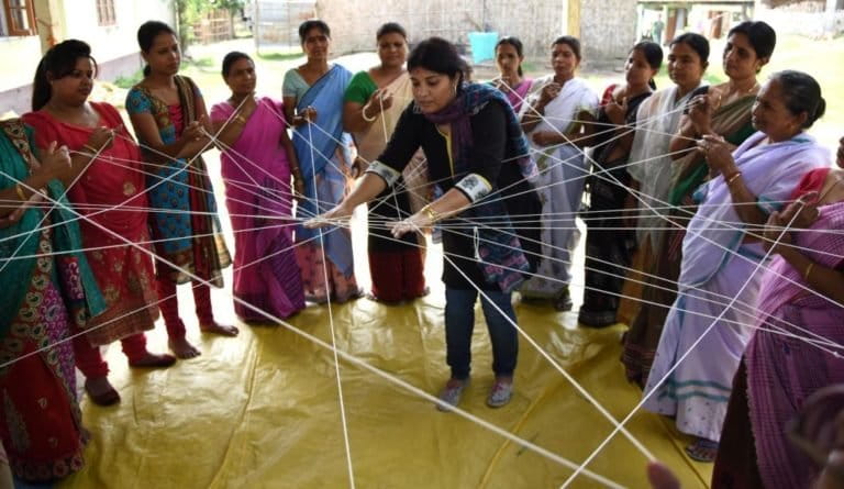 Purnima Barman educates village women through the web of life game. Photo courtesy of Aaranyak