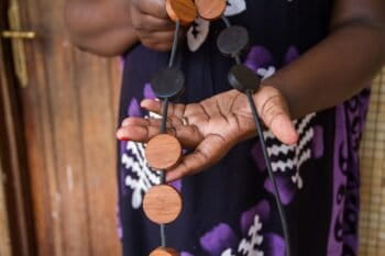 A necklace made from mpingo and another local hardwood. Mpingo’s dark, lustrous properties has made it one of the most valuable timbers in the world. Photo by Sophie Tremblay for Mongabay