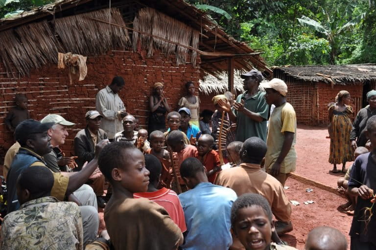 Geographer Tom Smith talks with the Baka in Somalomo village in South Cameroon. Photo by: Trevon Fuller.