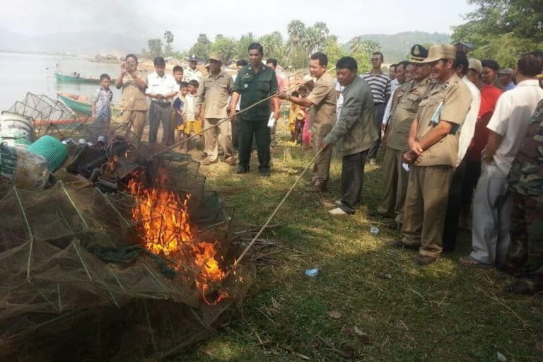 Members of the Kep provincial government and Fisheries Administration set fire to a mound of banned fishing gear in July 2015. The gear had been confiscated over a period of months from Cambodian and Vietnamese vessels operating illegally in Kep Bay, and was burned in front of a village notorious for abusing the law and the sea. Photo courtesy of MCC.