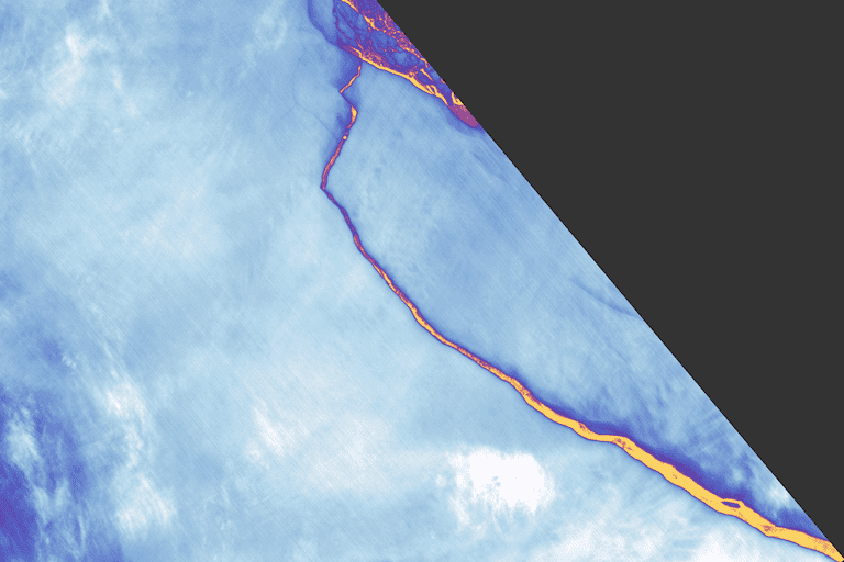 On July 12, 2017, the Landsat 8 satellite’s Thermal Infrared Sensor captured this false-color image of iceberg A-68 breaking away from Antarctica’s Larsen C ice shelf. Orange shows the warmest areas, particularly the crack between the iceberg and the ice shelf; light blues and whites show the coldest areas, including the nearly 2,240-square-mile (5,800-square-kilometer) iceberg and the ice shelf themselves. Image courtesy of NASA. 