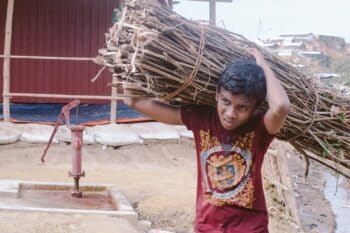 A Rohingya boy carrying a load of firewood through Kutupalong-Balukhali refugee camp in Bangladesh. Photo by Khaamil Ahmed/Mongabay.