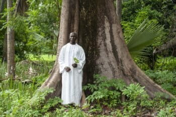 Bassirou Sambou, who heads the biodiversity monitoring section of Kawawana, stands in the ancient woodland surrounding his home. Image by Jennifer O’Mahony for Mongabay.