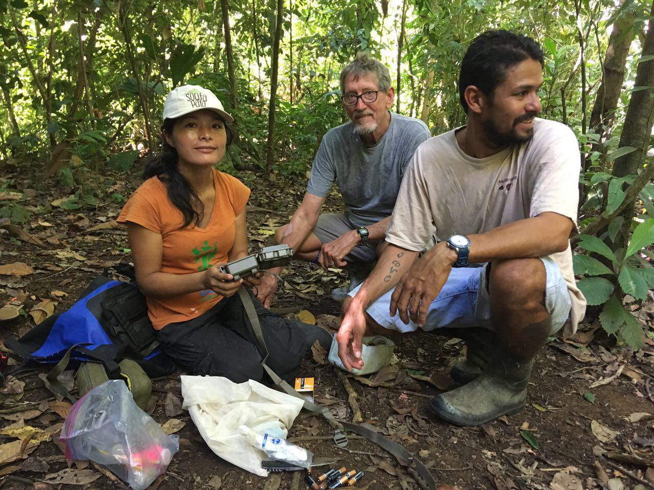 OC biologist Ruthmery Pillco Huarcaya accompanying Saladero Eco-Lodge owner Harvey Woodard and boat captain David on the edge of Piedras Blancas National Park installing camera traps.