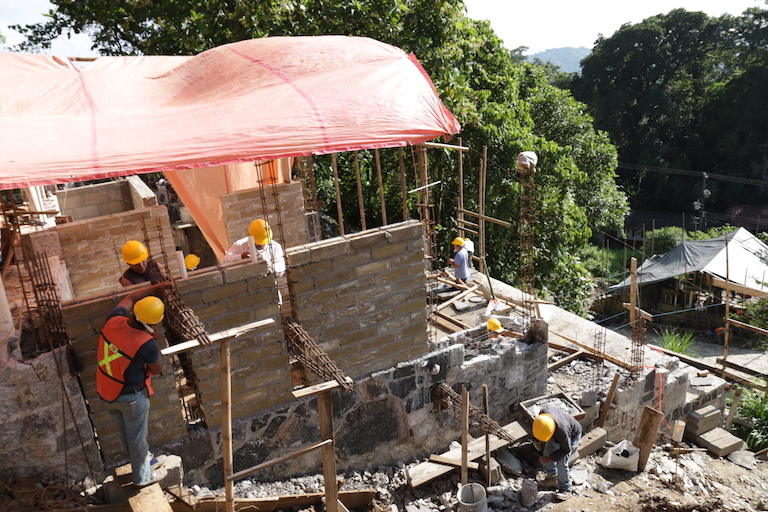 Construction underway at the Tosepan cooperative's housing development in Cuetzalan. When the buildings are complete, the youth solar team will be hired to install solar panels. Image by Ethan Bien for Mongabay.