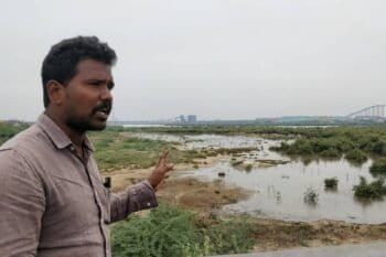 Saravanan points to a large salt pan, part of Ennore Creek in the city of Chennai. The nearby port’s plan to convert the area into industrial real estate sparked protests among fishing communities in 2016. Image by Mahima Jain.