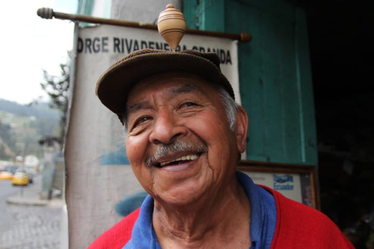 Jorge Rivadeneira Granda spins a top on his haed outside his shop in Quito, Ecuador. Photo by Kimberley Brown for Mongabay.