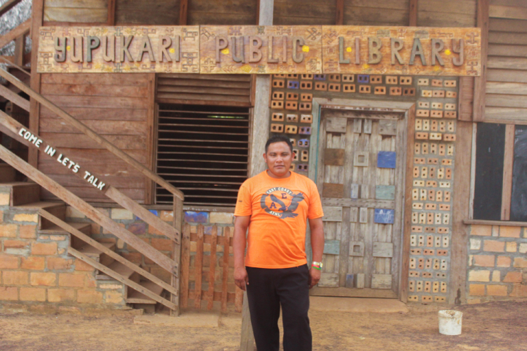 The Tashao of Yupukari, Russian Dorrick, in front of the community library in 2018. Photo by Ereika DeAndrade.