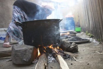 The primary reason for large plantations of Eucalyptus is for cooking. Here a woman makes a traditional non-alcoholic beer served at Islamic celebrations. Photo by Christopher Lett/Mongabay.