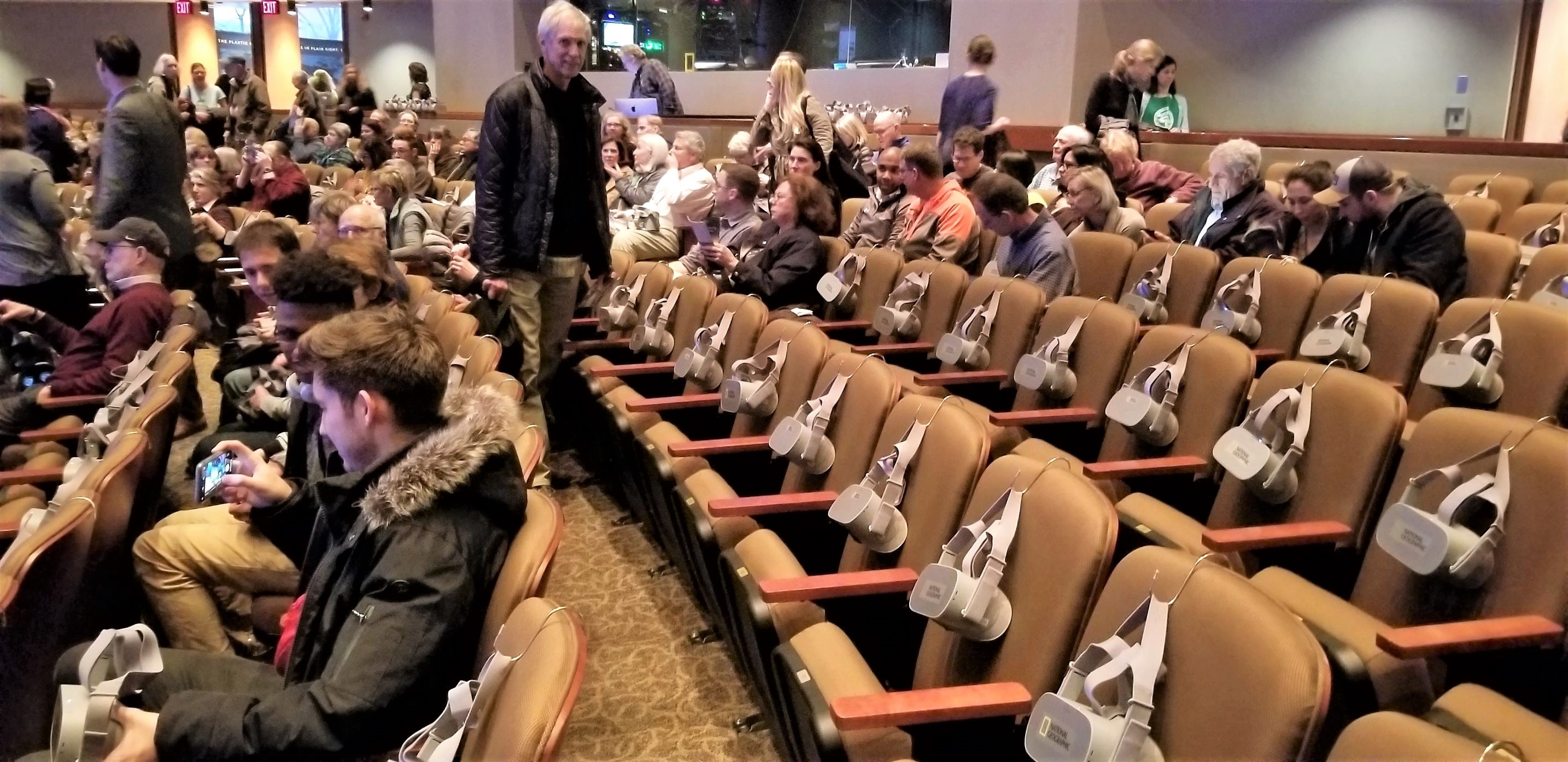 The VR-equipped auditorium at National Geographic. The use by a well-financed NGO of standard $200 Oculus Go goggles hooked onto the backs of the chairs demonstrates that groups with smaller budgets can also use VR-360 technology for their outreach efforts.