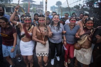 Indigenous Waorani march through the streets of Puyo after their legal victory against the government, during a strong downpour. Photo by Mitch Anderson/Amazon Frontlines.