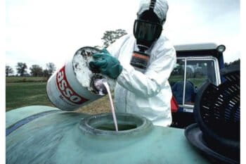 Monsanto Lasso herbicide to be sprayed on food crops showing proper protective gear. Photo courtesy of the USDA