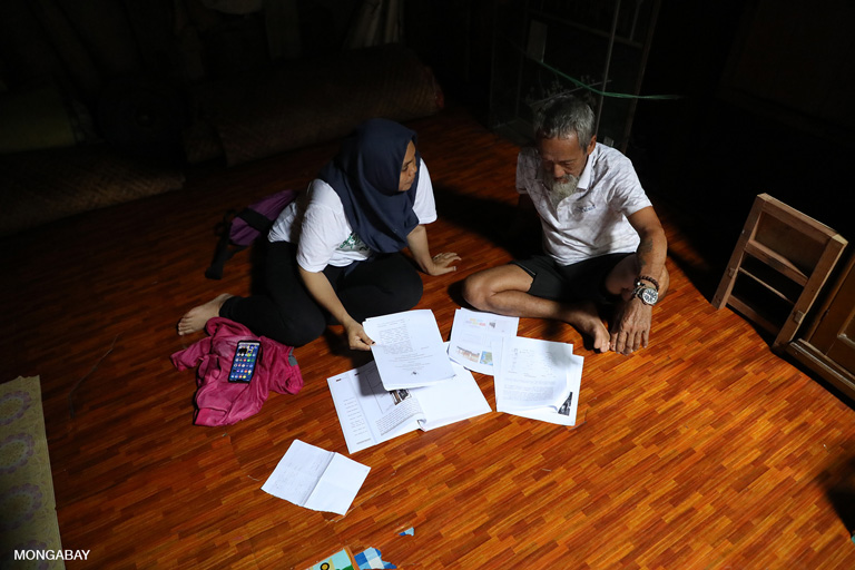 Aseanty going over community documents and historical records with Bandi at Sungai Utik. Photo by Rhett A. Butler