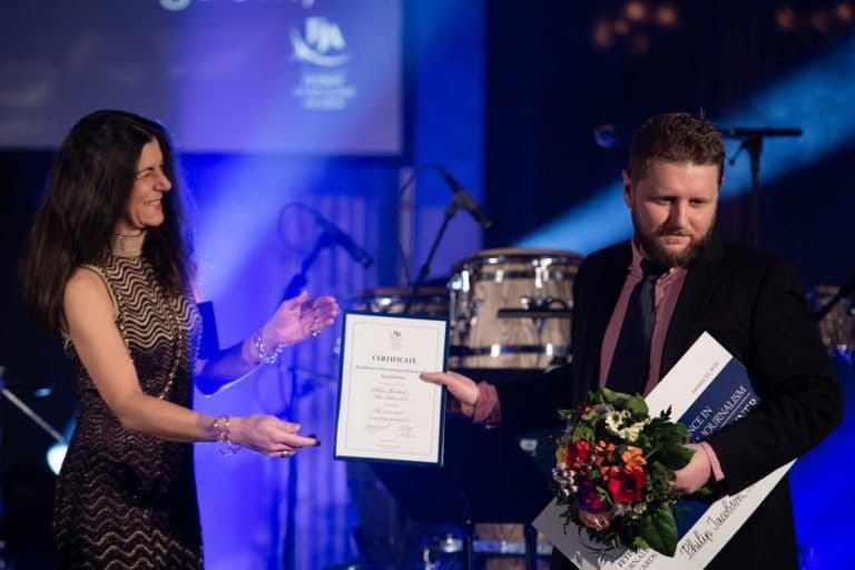 Barbara Trionfi, executive director of the International Press Institute, presents second prize for the Fetisov Journalism Award's Excellence in Environmental Journalism category to Tom Johnson at a ceremony in Lucerne, Switzerland, on January 22, 2020. Jacobson was expected to attend the awards ceremony in Switzerland but couldn't due to his detainment. Jacobson and Johnson were honored for their work on “The secret deal to destroy paradise,” a 22-month investigative expose on the Tanah Merah project, which aimed to clear 2,800 square kilometers of forest for oil palm plantations in Papua, on the island of New Guinea. Photo courtesy of Fetisov Journalism Award.