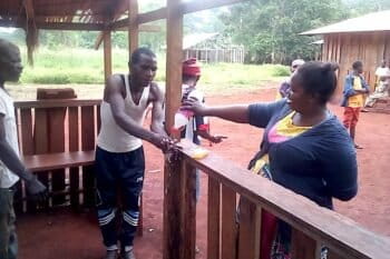 In Mambele, in Eastern Cameroon, an indigenous Baka woman is raising awareness of other Baka indigenous communities on the importance of washing hands to prevent COVID-19. May 2020. Image courtesy of OKANI.