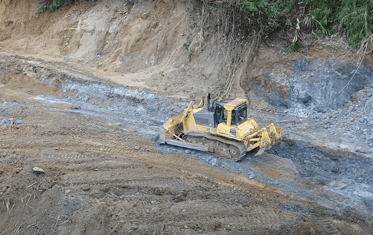 A bulldozer clears land on Woodlark. Image from Geopacific Resources via Youtube.