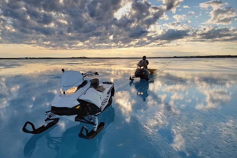 Ryan Angohiatok and Ivor Maksagak venture out on the sea ice south of Cambridge Bay to measure ice thickness. Credit © Ryan Angohiatok.