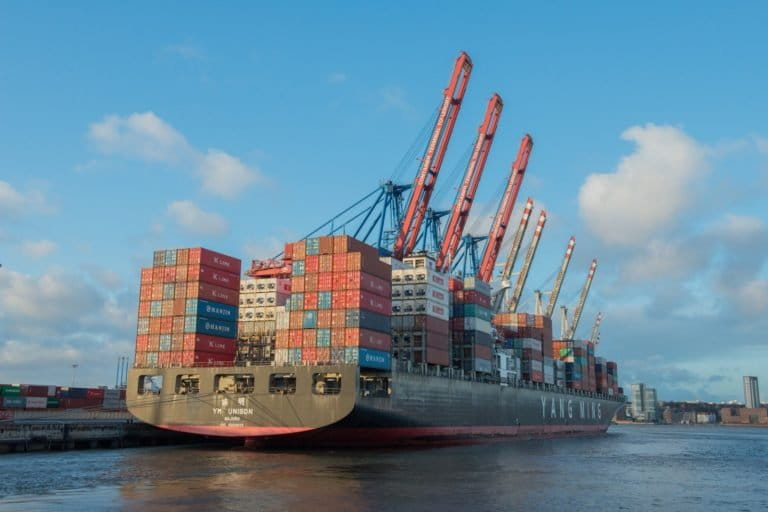 A loaded container ship docked in Hamburg, Germany. Image via Visualhunt.