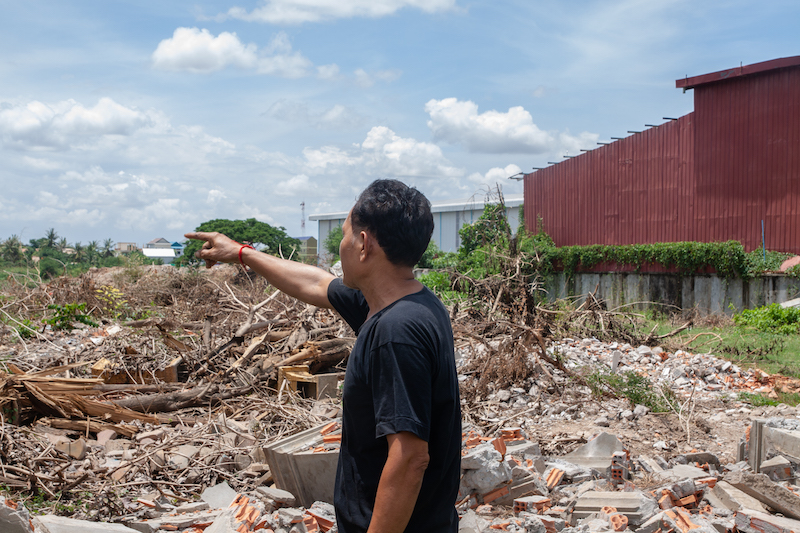 Touch Soeun gazes at his land, which has been cleared without his consent in June 2020. Image by Gerald Flynn.