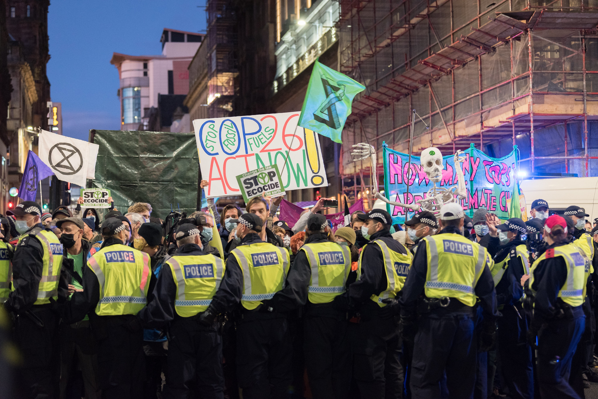 3 November 2021, Glasgow, Scotland, United Kingdom: 'Justice for the Global South', 'Stop Ecocide' and 'COP26 Act Now, Stop Fossil Fuels' reads a series of signs, as climate activists from the group Extinction Rebellion take to the streets of Glasgow under heavy police presence to protest against political inaction on climate change, and to demand climate justice, now. The protest takes place as Glasgow hosts the United Nations climate change conference COP26, where world leaders gather to negotiate a response to the ongoing climate crisis and emergency. Photo: LWF/Albin Hillert