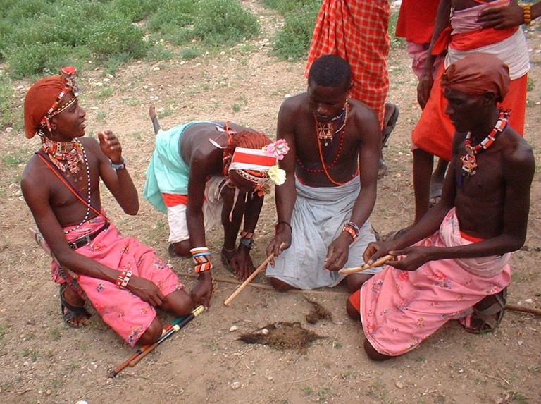 Samburu men, pictured here in northern Kenya, starting a fire. Image by Moongateclimber via Wikimedia Commons (CC BY-SA 3.0).