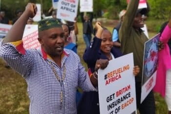 Protestors with signs protesting EACOP, ReconAfrica projects. Image courtesy 350.org
