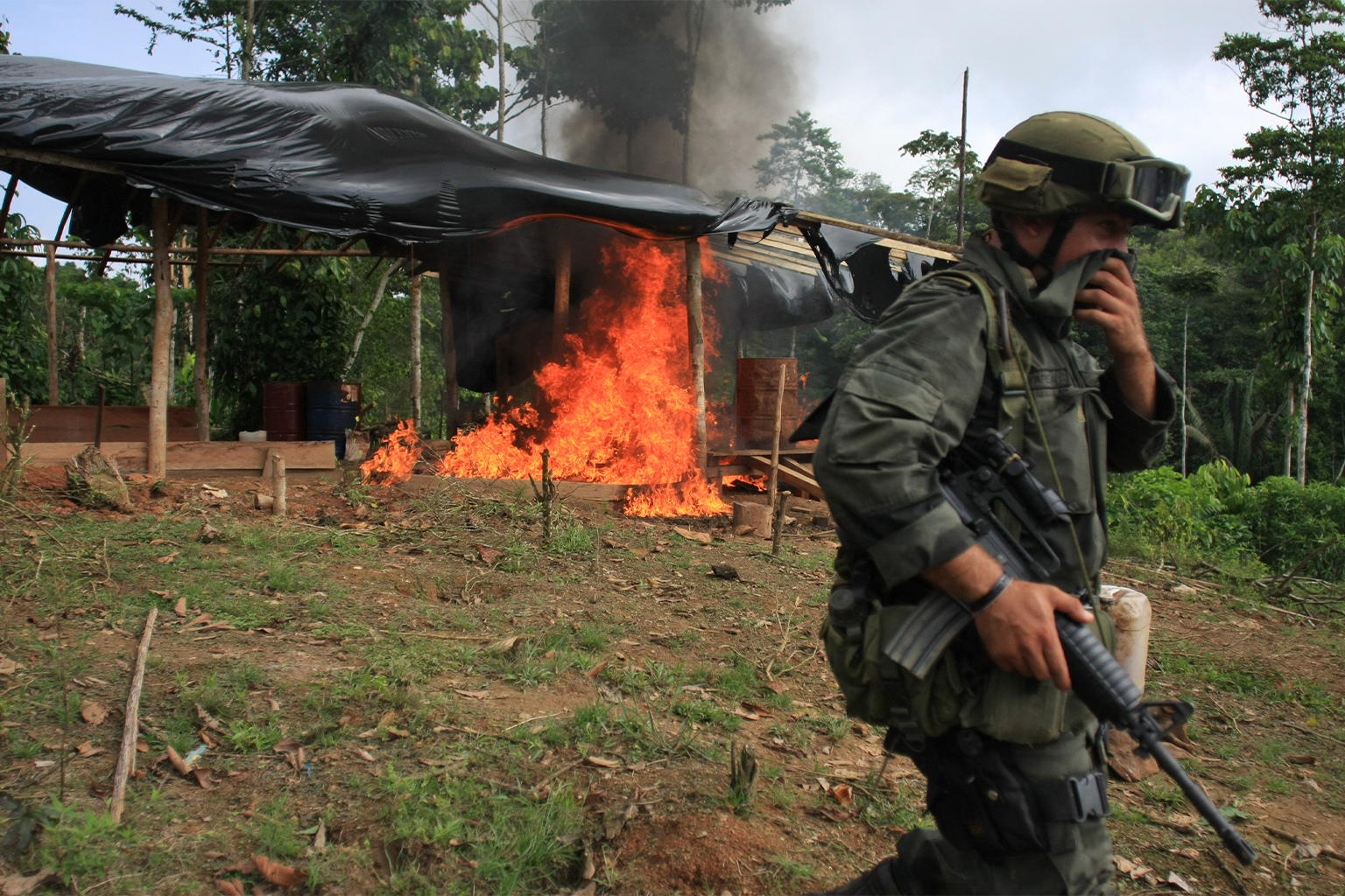 Police officers burn a coca laboratory in Tumaco, Colombia, in 2008. 