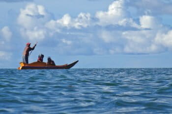 Fishermen in a small boat at sea in Koror, Palau.