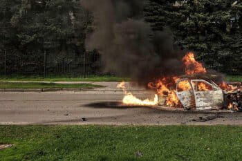 A car burns with two people inside, after a Russian bombardment in Kharkiv, Ukraine, Thursday, April 21, 2022. Image by AP Photo/Felipe Dana via Flickr.