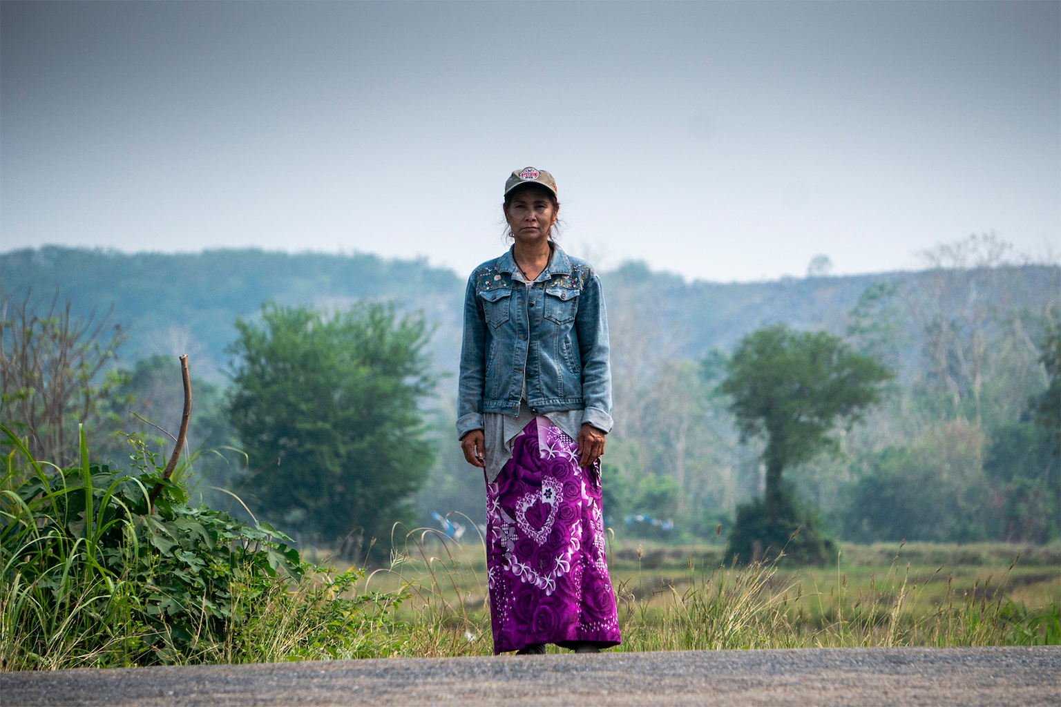 Pranom Chimpalee at her house. Behind is the mine pit.