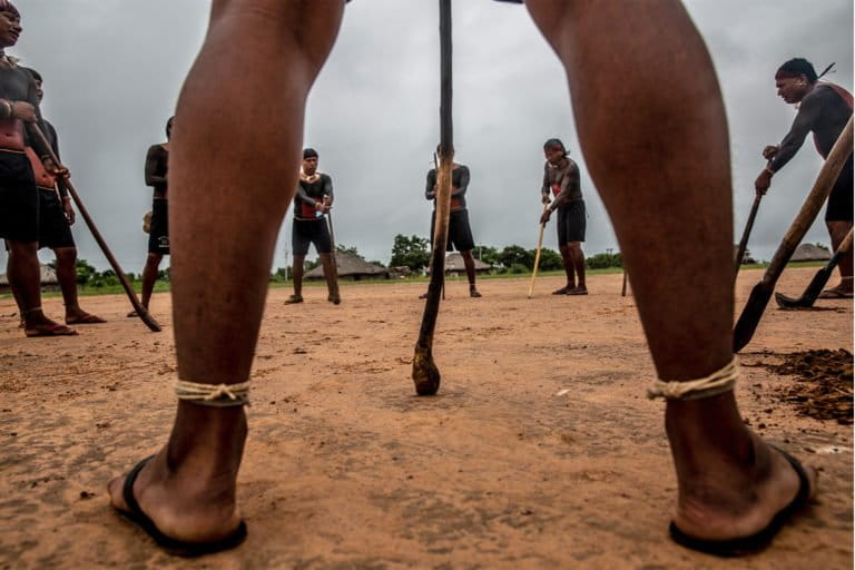 Indigenous Xavante warriors sing and gather their weapons at the center of the Ripá tribe to decide their collective action after confirming an invader is mining sand in the slopes of the Roncador mountain range, allegedly inside Pimentel Barbosa Indigenous reservation in Mato Grosso.