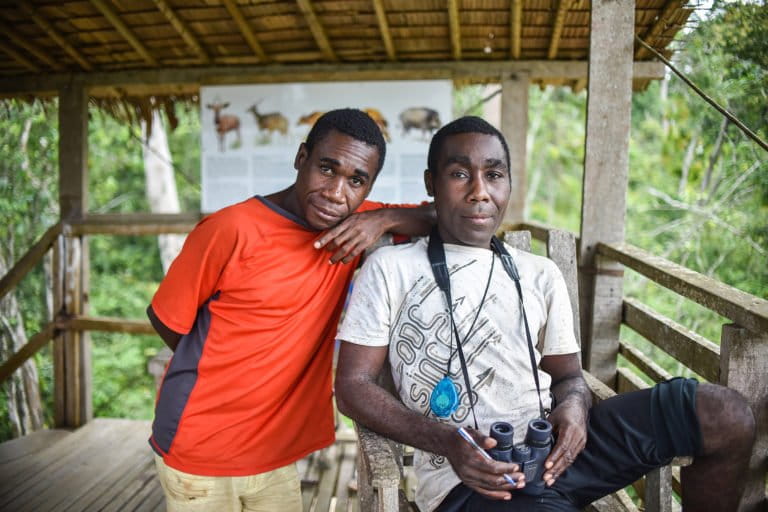 Bonga and his brother, Mobeawe, collecting data on forest elephant entrances into Dzanga Bai in 2018. Image courtesy of Ana Verahrami/Elephant Listening Project.