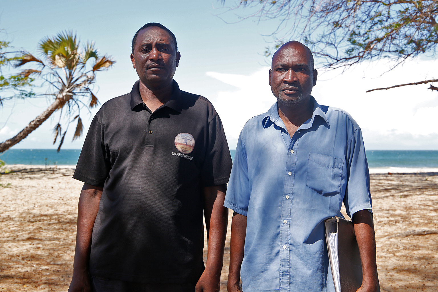 Meshak Katana, the Executive Director, (in black) and Moses Karisa, the Vice Chairman of the Marereni Biodiversity Conservancy, after the mangrove planting and beach clean-up activities