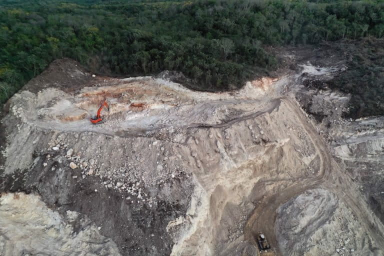 The extraction of stone to be used in the construction of the Tren Maya project. On March 15, 2022, from the stretch of the Campeche-Mérida Federal Highway around the town of Pomuch, Hecelchakán, Campeche, one could see excavation on the neighboring mountains being carried out by diggers. Image courtesy of Robin Canul.