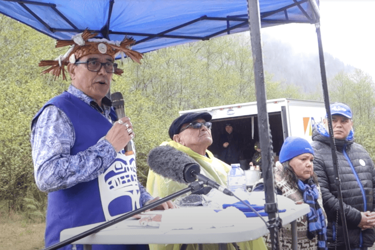 Chief Powell speaks before the event dedicating the land as the Gwa̱xdlala/Nala̱xdlala (Lull Bay/Hoeya Sound) Indigenous Protected and Conserved Area. Image courtesy of Erica Gies. 