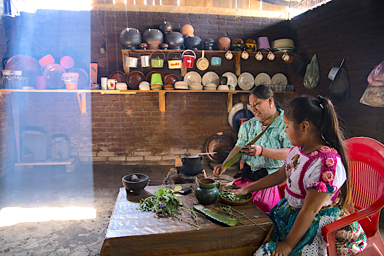 Juana Bravo prepares an antiseptic salve with her niece Cuchita. Image by Monica Pelliccia for Mongabay.