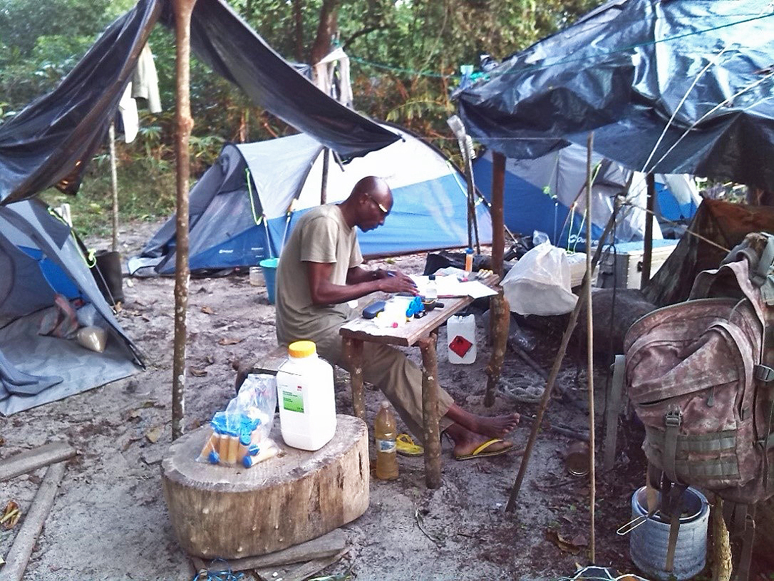 Emmanuel Dilambaka processes samples in a field lab