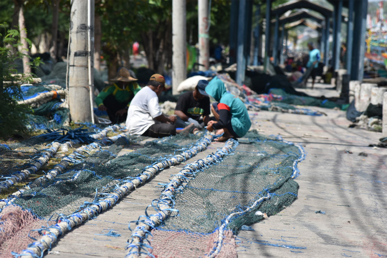 Fishers mend cantrang nets.