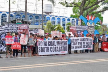 Activists and Indigenous peoples holding a protest.