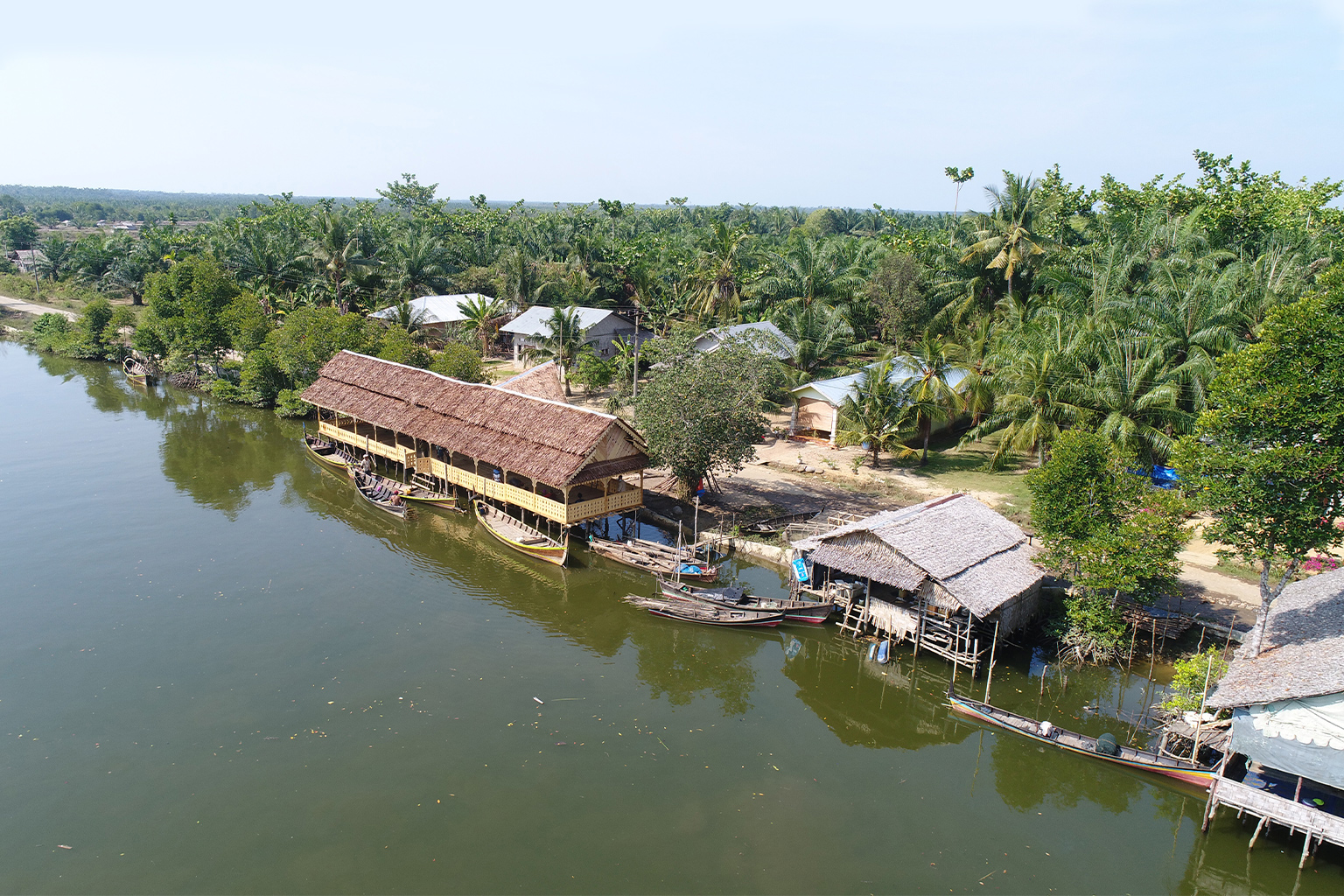 Buildings and boats at the Sicanang mangrove rehabilitation project.