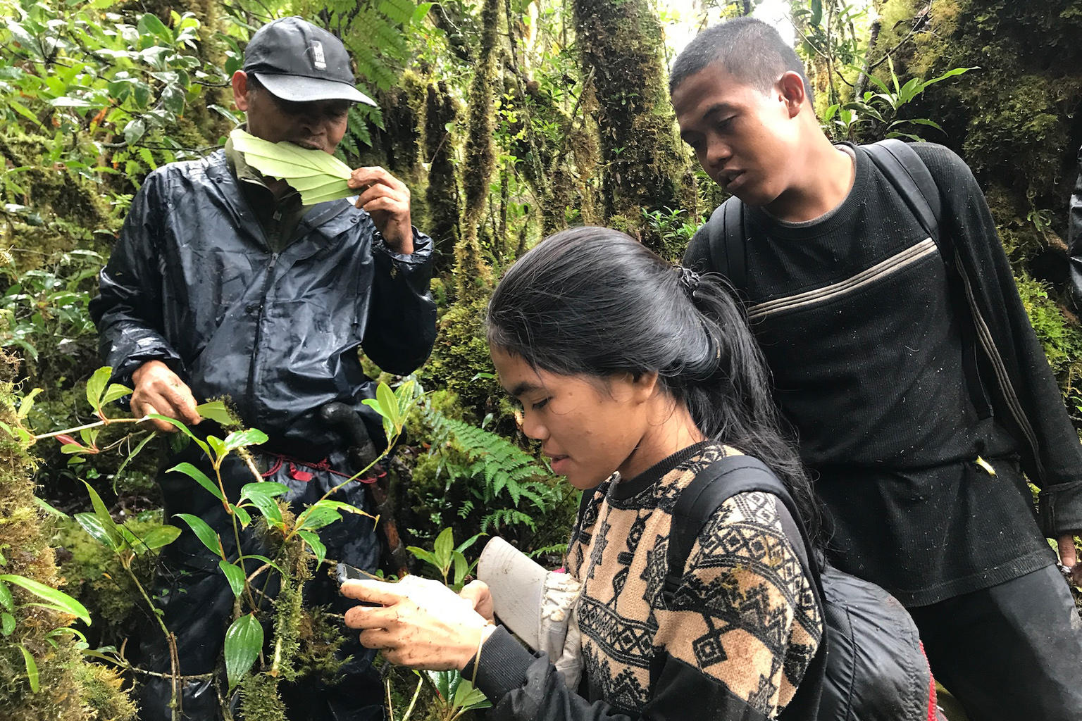 Enrique with elders in the forest.