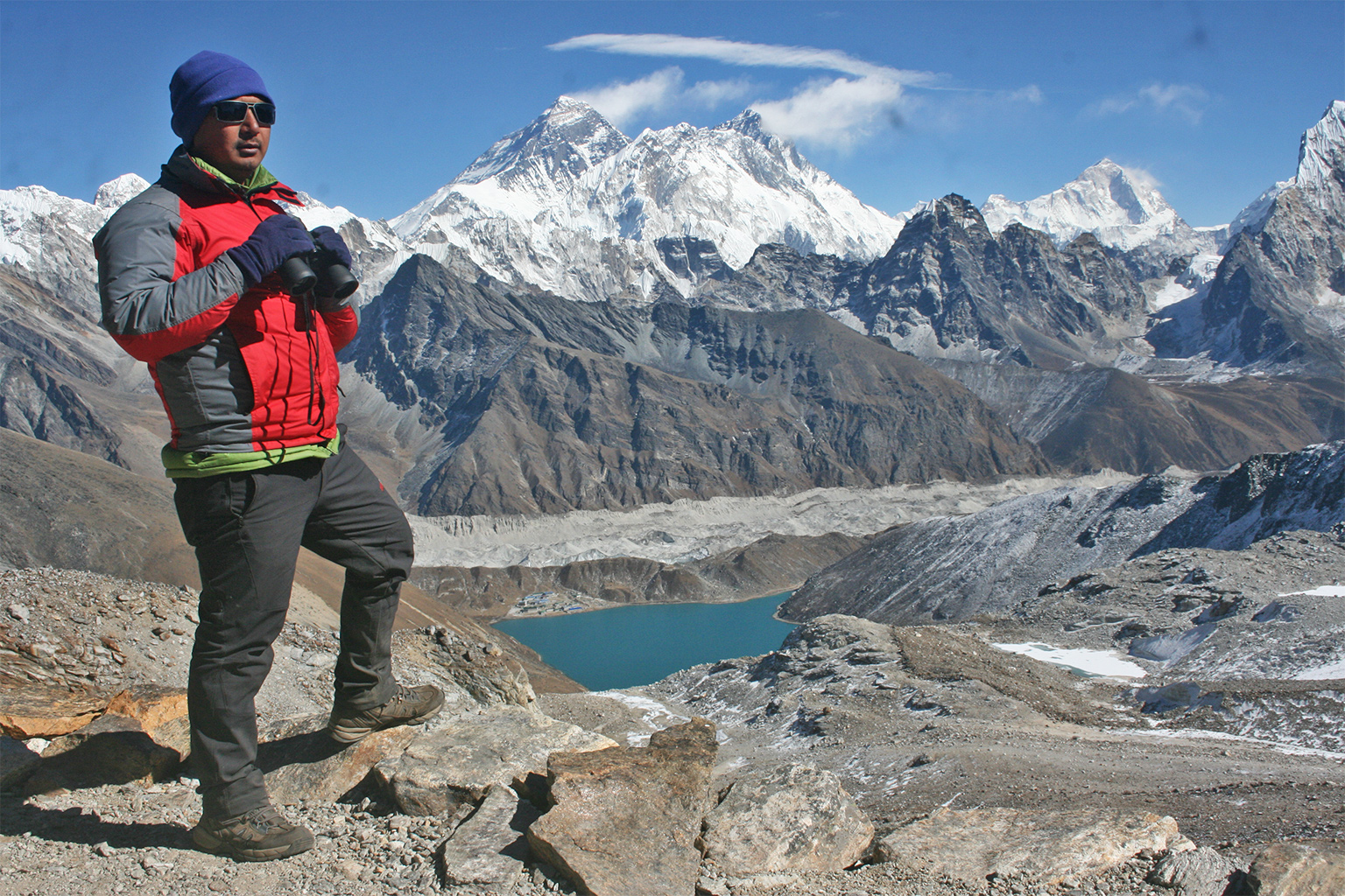 Researcher Bikram Shrestha scanning the Gokyo valley with Sagarmatha mountain in the background.